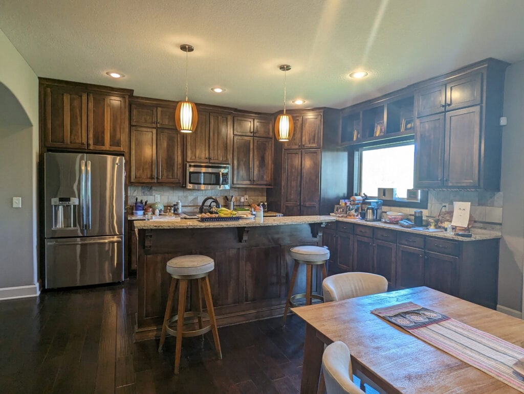 Kitchan Giallo Ornamental or Venetian gold granite countertops, dark wood stained cabinets, dark wood flooring, island.