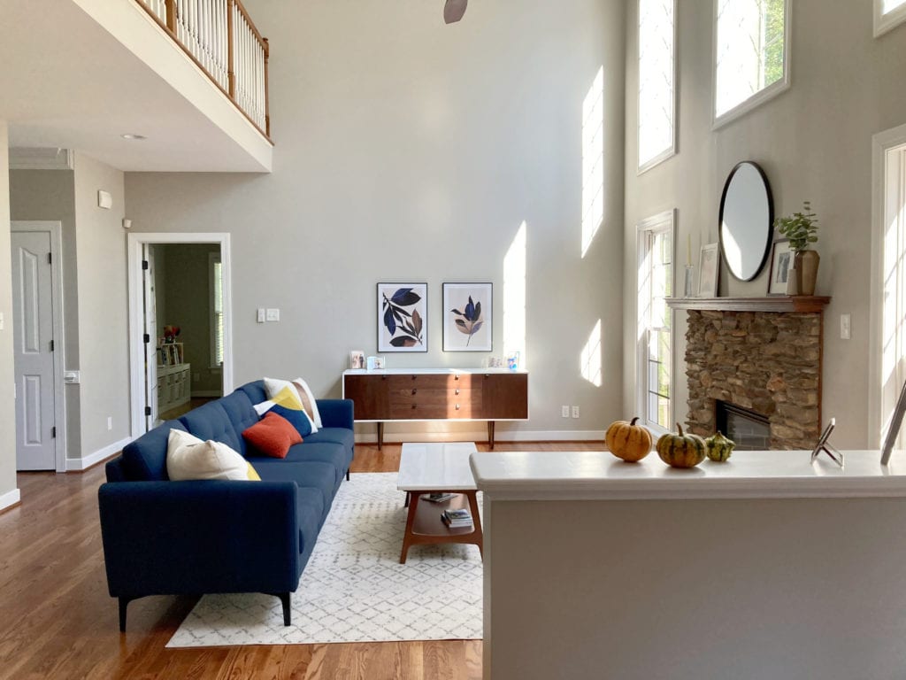 Living room with high ceiling, Benjamin Moore Edgecomb Gray walls, greige taupe paint colour, oak floor, navy blue sofa. Kylie M Interiors Edesign, client photo