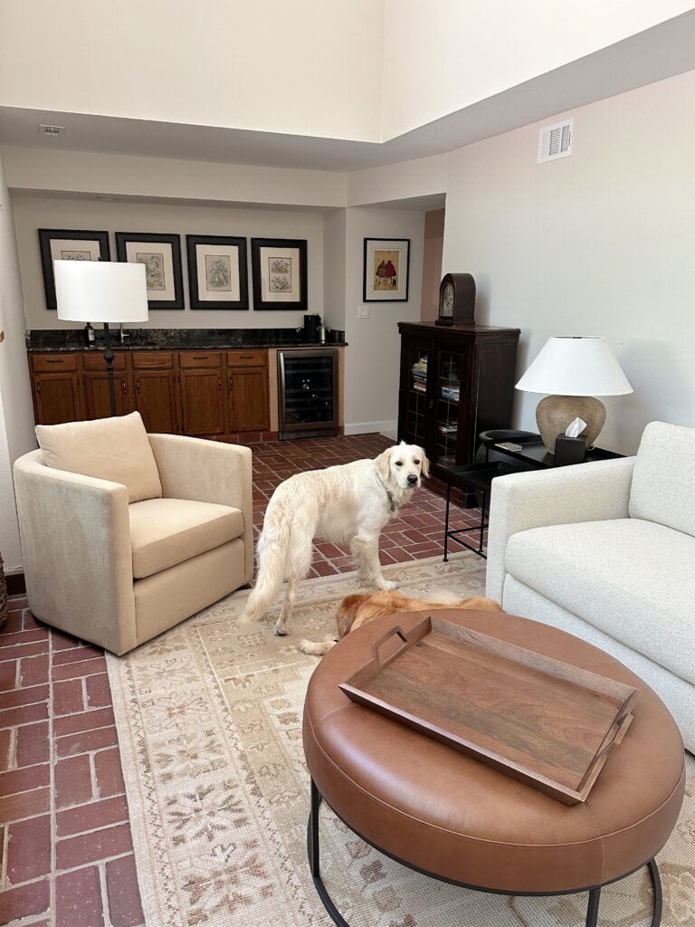 Red pink brick floor in family room, terra cotta tile colors, Sherwin Williams White Duck paint color on walls, wet bar with granite, neutral furniture