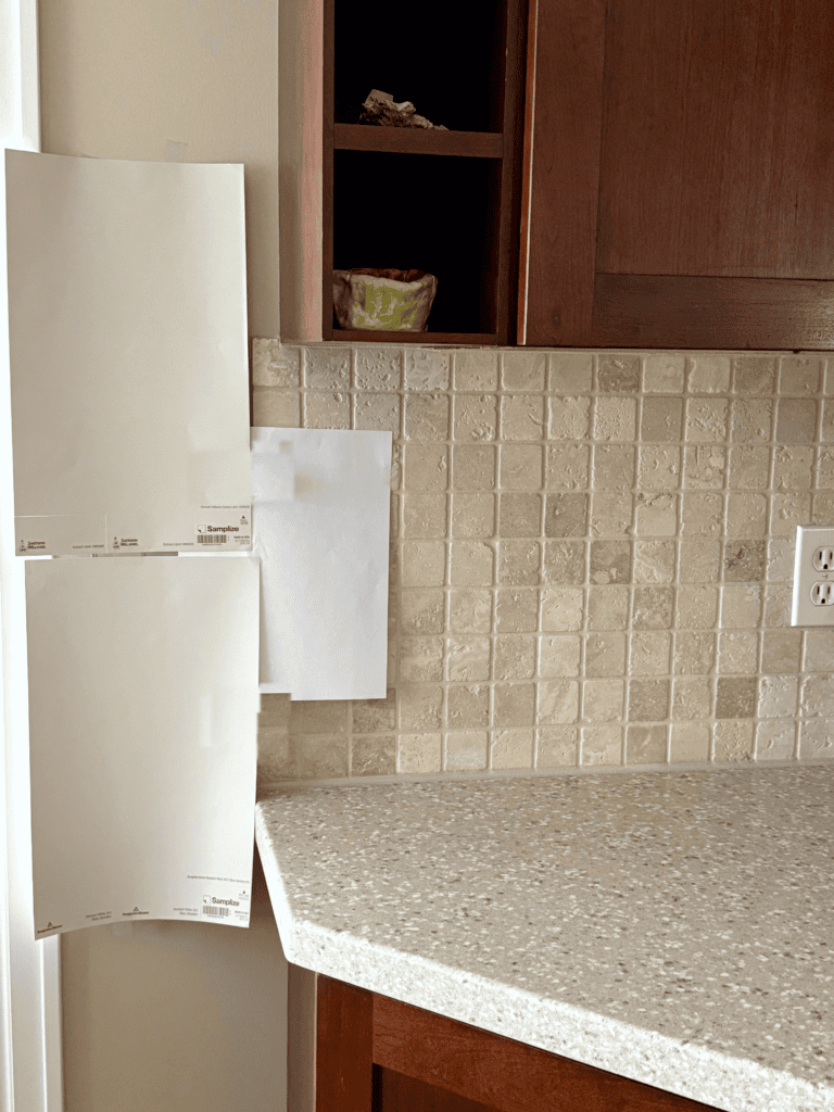 Samplize peel and stick paint samples, popular shades of beige with travertine tile backsplash, cherry, red stained wood cabinets, beige countertop