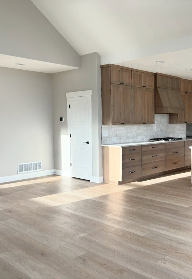 Sherwin Williams Agreeable Gray paint color on walls, Pure White trims, Wood alder, oasis stained kitchen cabinets, wood floor, gray wash