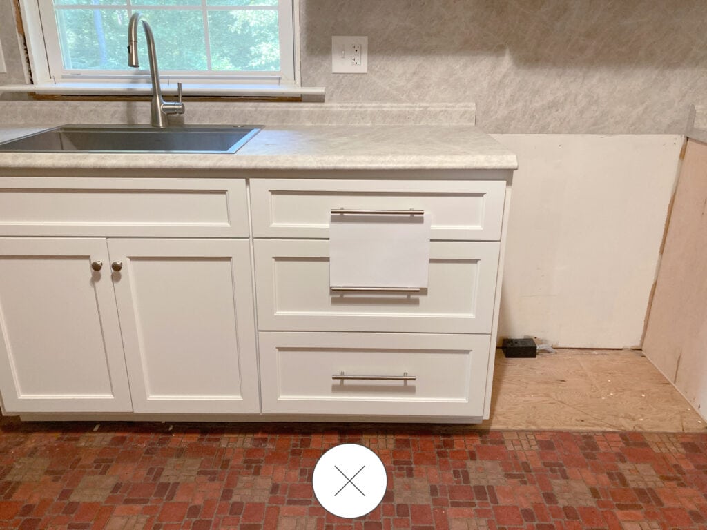Sherwin Williams Pure White painted kitchen cabinets, Formica laminate countertop in Taj Mahal on backsplash as well