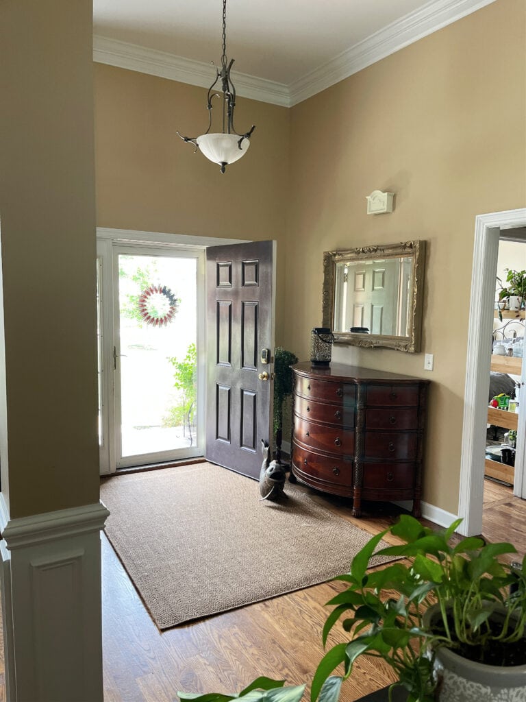 Sherwin Williams Quinoa warm beige paint color, provincial stain wood oak floor, entryway, front door. Pure White trim