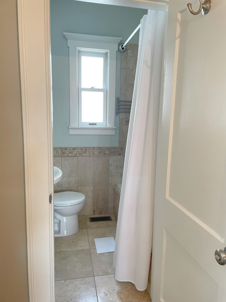 Sherwin Williams Sea Salt in bathroom with travertine tile