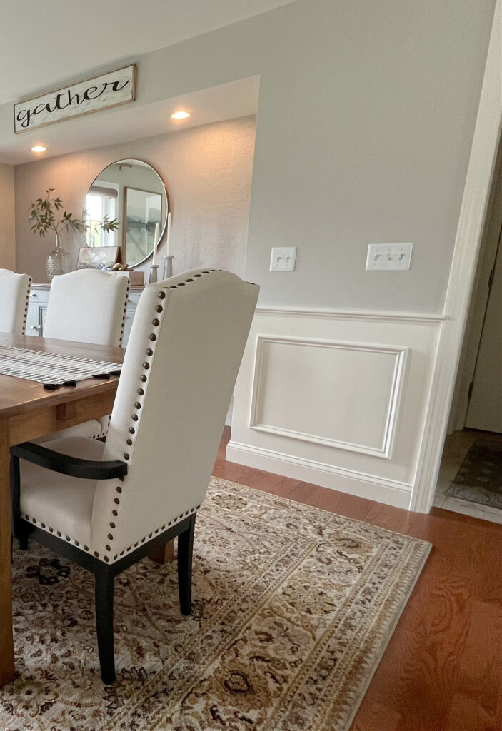 Sherwin Williams Worldly Gray, warm gray greige paint color ion dining room, oak floor, BEnjamin MOore White Dove trim, ceiling, wainscoting, drapes and niche or alcove (1)