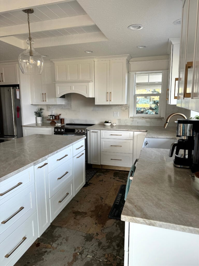 Taj Royal quartzite with painted kitchen cabinets, gold brass hardware