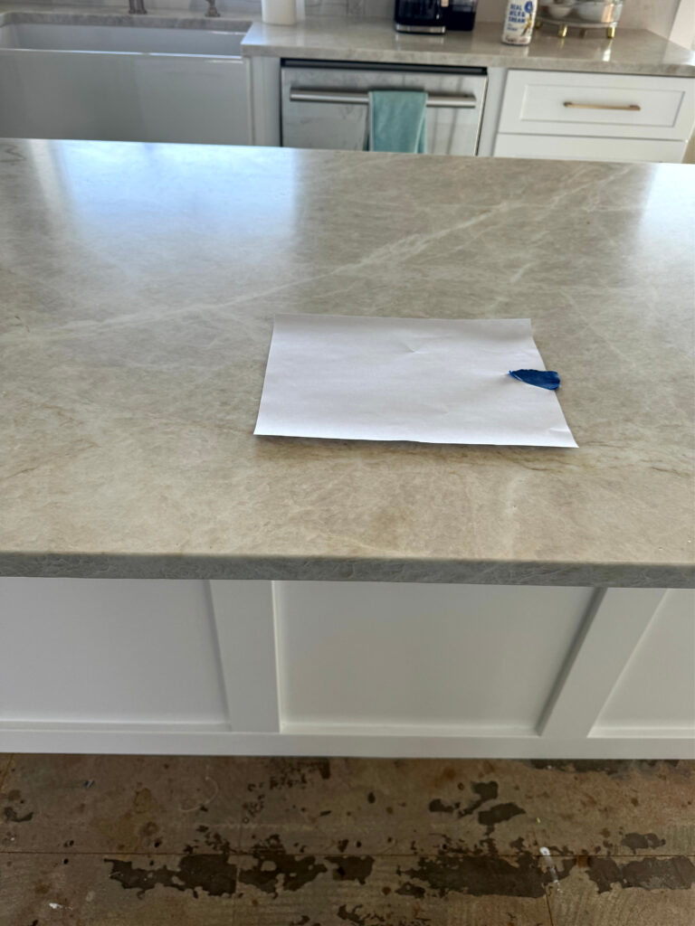Taj Royal quartzite with white painted kitchen cabinets