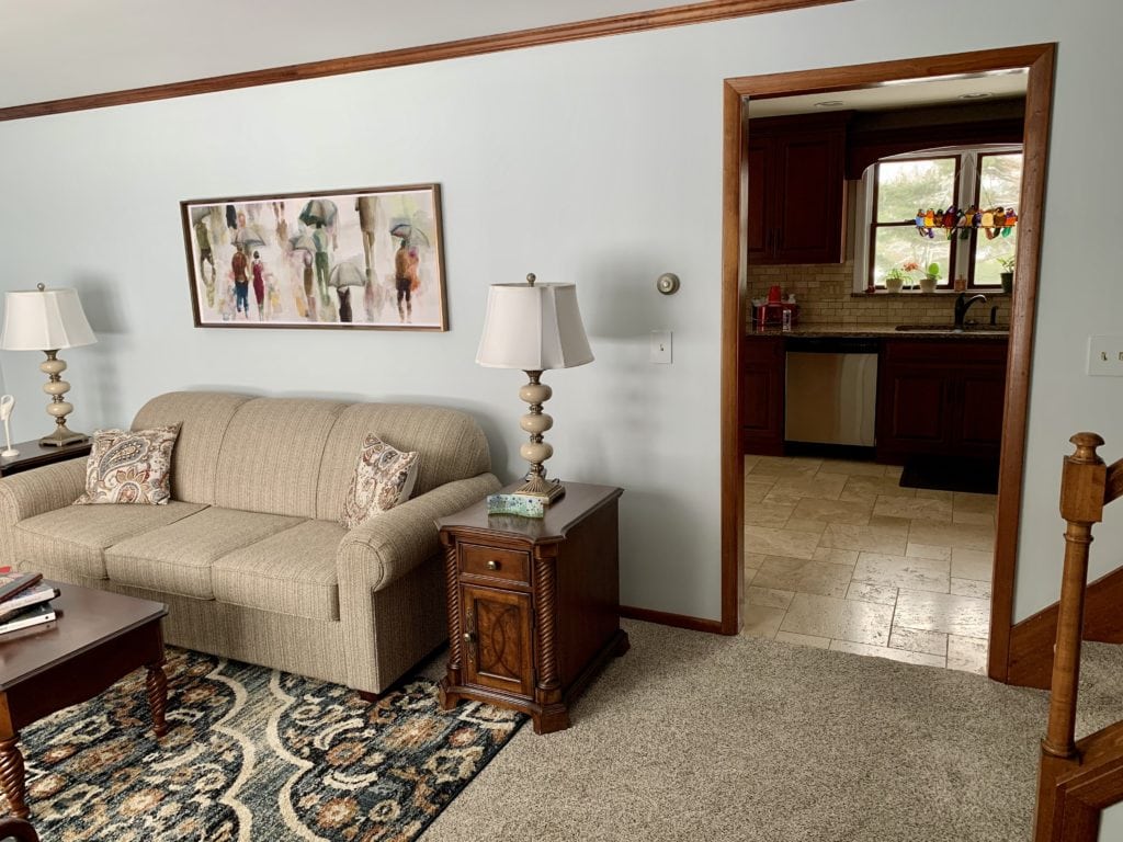 Wood trim and beige sofa, tile an