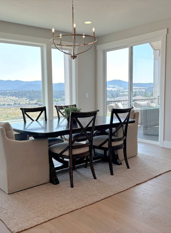 dining room with area rug, upholstered and wood cross back chairs, gold chandelier, Sherwin Williams Agreeable Gray, Pure White trim and wall paint colors
