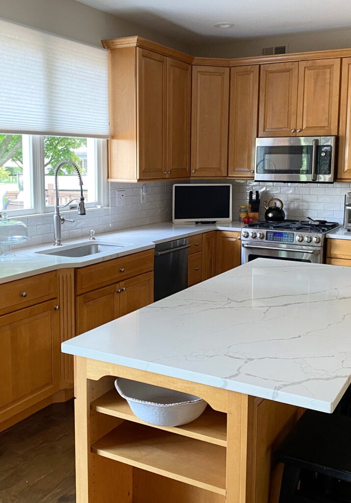 kitchen with maple wood cabinets, white subway tile backsplash, Calacatta Laza MSI white quartz countertop, stainless steel appliances (1)