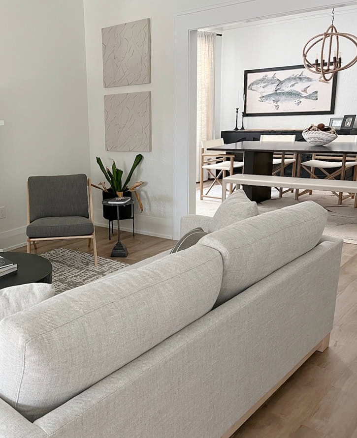 living room with large white fireplace surround, Greek Villa warm white on walls, Extra White trim , shotgun to dining room, neutral home decor and furniturre (1)