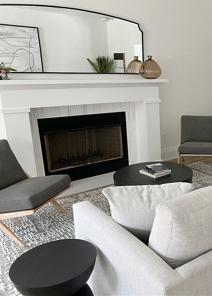 living room with large white fireplace surround, Greek Villa warm white on walls, Extra White trim , shotgun to dining room, neutral home decor and furniturre (2)