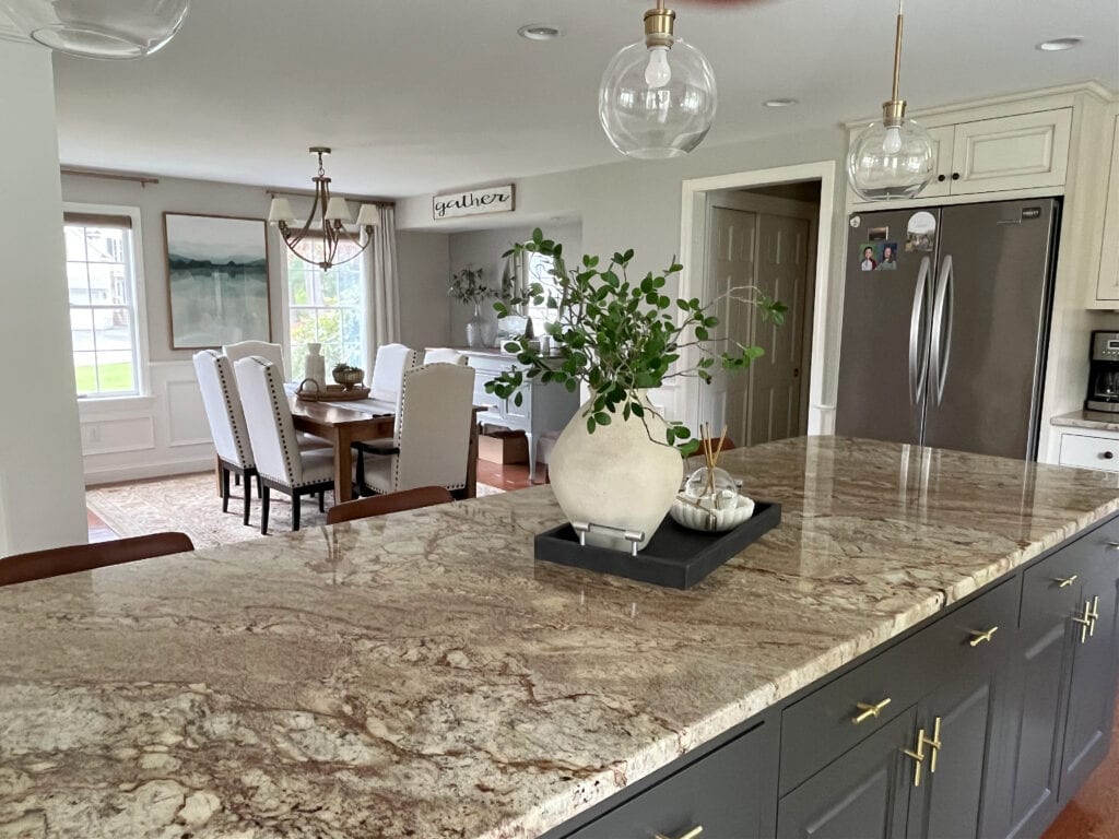 Sherwin Williams Urbane Bronze on goldne beige vein granite countertop, Sherwin Williams Worldly Gray paint color in dining room, gold pendant lights