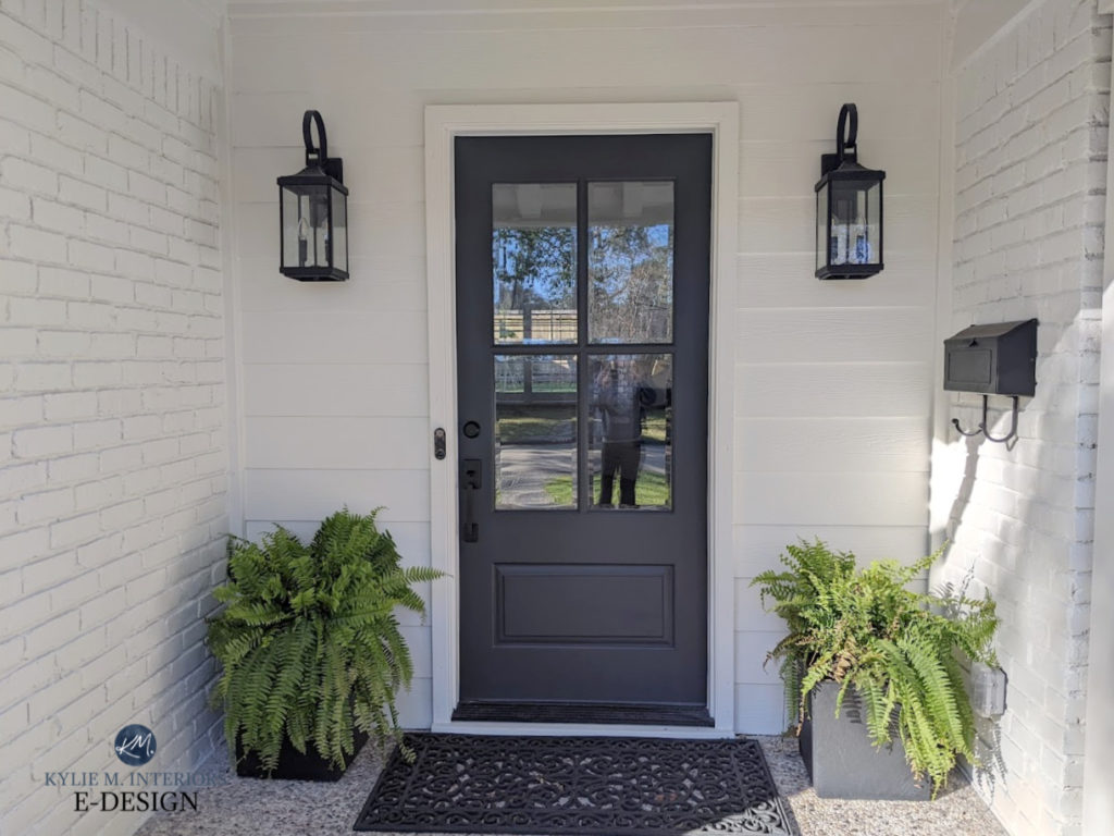 Benjamin Moore Cheating Heart, dark blue black front door, Seapearl exterior painted brick with black light fixtures. Kylie M Interiors Edesign