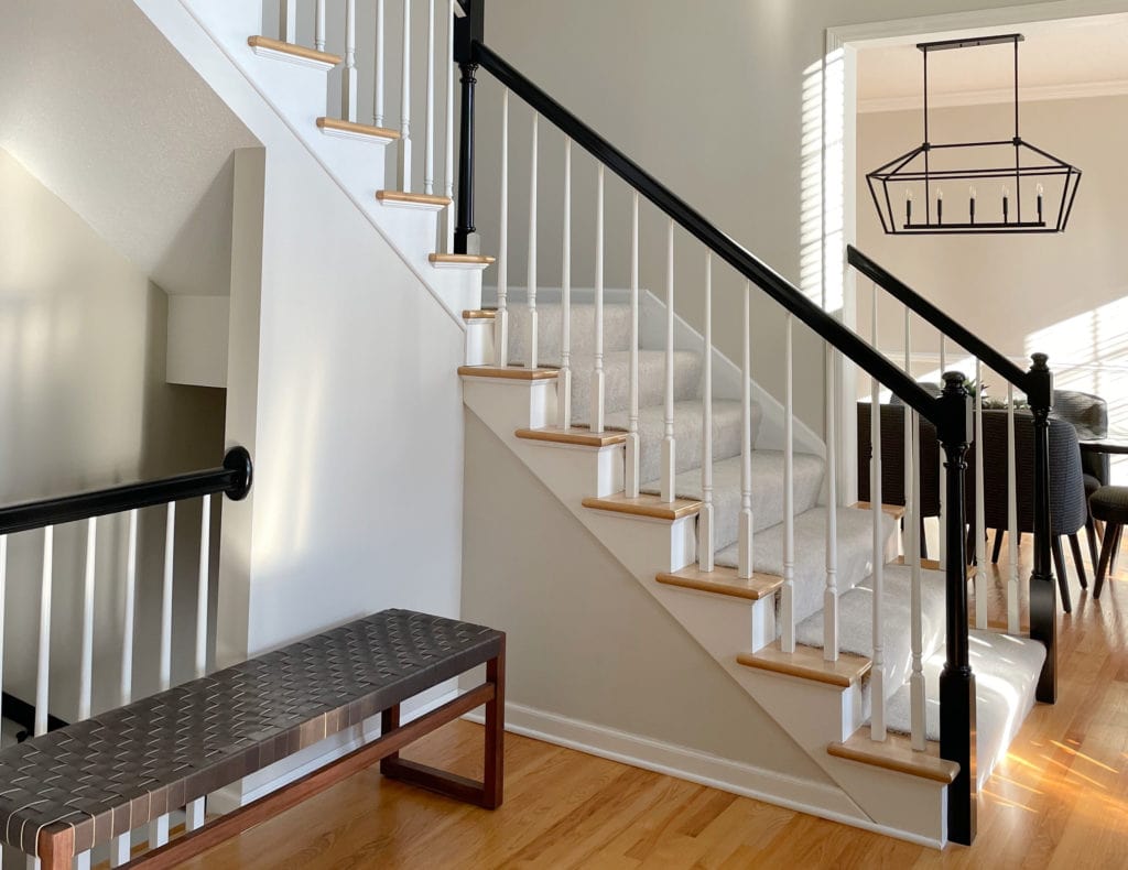 Benjamin Moore Edgecomb Gray in foyer, staircase with carpet, south facing exposure, orange oak floor. Client photo Kylie M Interiors