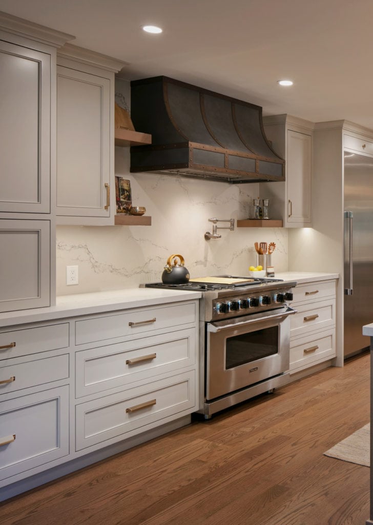 Kitchen in Benjamin Moore Revere Pewter (painted cabinets darkened). Quartz countertops. Caesarstone Statuario Nuvo Red oak wood floor, Pendant lights, metal range hood, Kylie M Edesigns