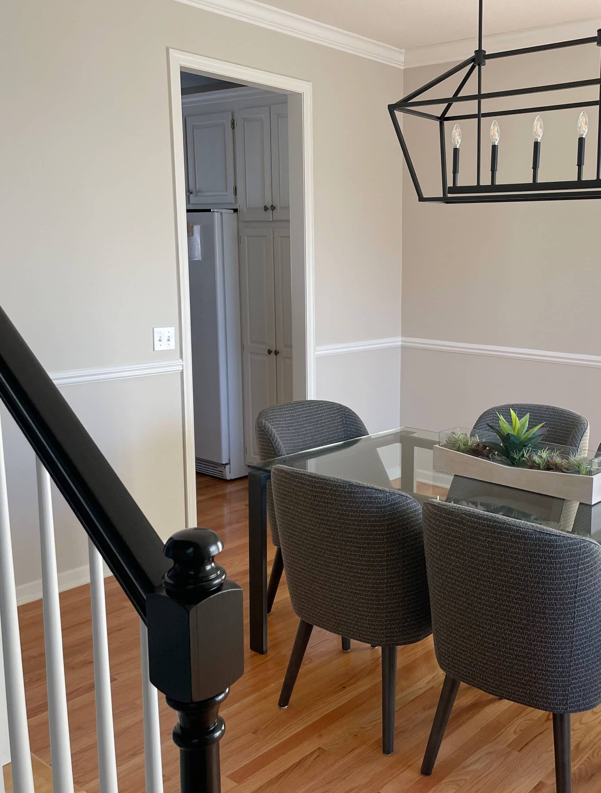 Orange hue oak flooring, Benjamin Moore Edgecomb Gray, greige taupe paint color on walls, south-facing dining room, chair rail. Kylie M Interiors edesign client BEFORE photo