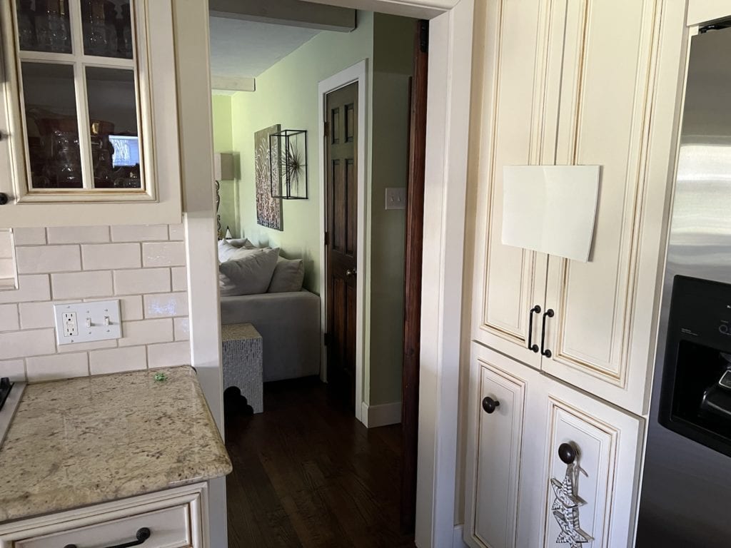Sherwin Williams Creamy warm offwhite paint color on cream cabinets, Antique White - it doesn't look good. Kylie M Interiors Edesign