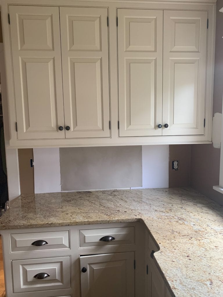 Sherwin Williams Versatile Gray with cream cabinets, similar to Antique White and granite countertops. Update ideas with Kylie M Interiors Edesign