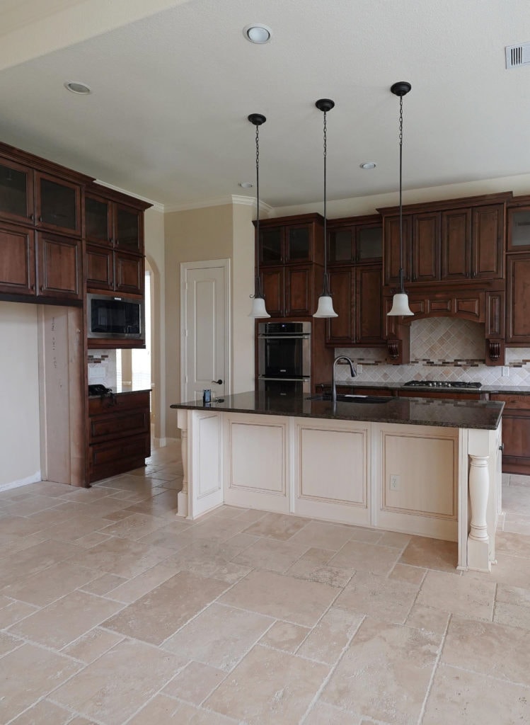 Travertine tile, Kitchen with Antique White glazed cream island cabinets, dark wood cabinets, best beige paint colour, Sherwin Williams Macadamia. Kylie M Interiors