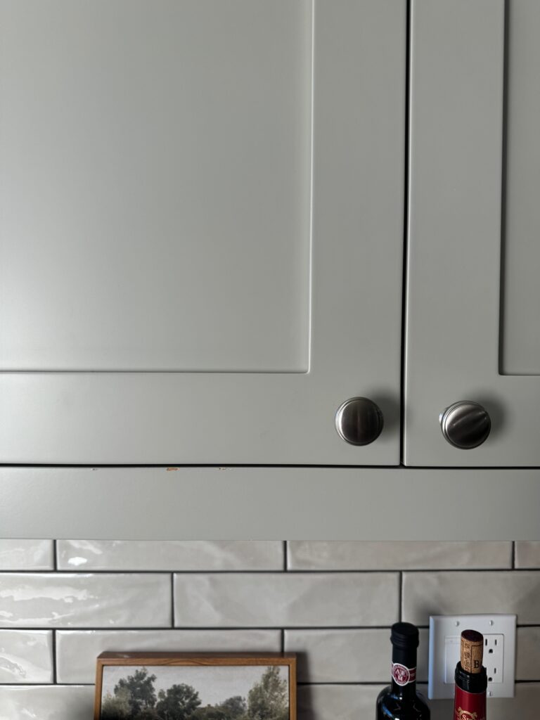 Benjamin Moore Revere Pewter painted kitchen cabinet, warm gray with subway tile backsplash, Kylie M.