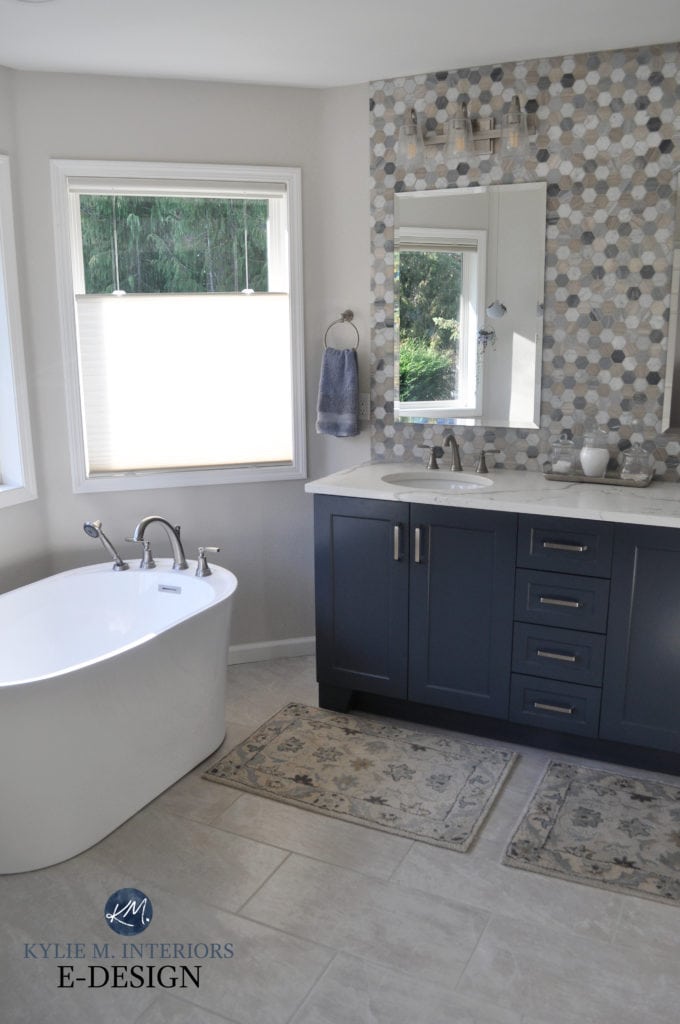 Bathroom, freestanding white tub, Benjamin Moore Hale Navy similar painted vanity, blue, white beige hexagon tile wall backsplash,. Sherwin Williams Egret White walls. Kylie M Interiors Edesign