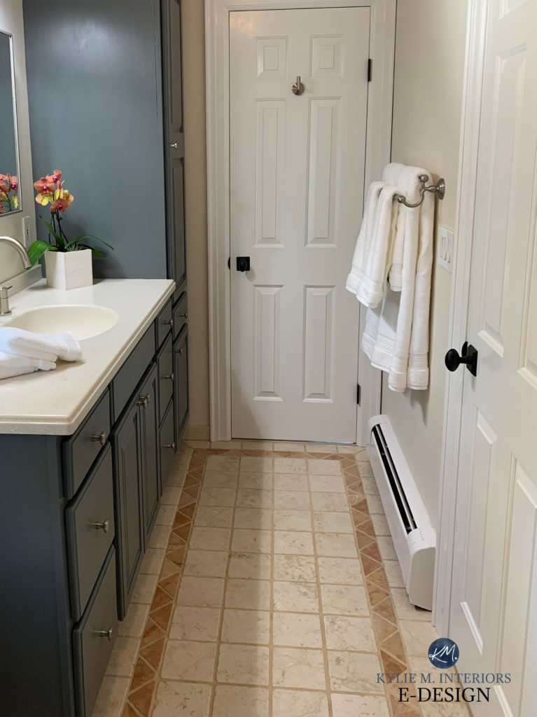 Benjamin Moore Kitty Gray painted oak wood vanity in bathroom, terra cotta tile, orange peach floor Moderate White paint color walls. Kylie M Interiors