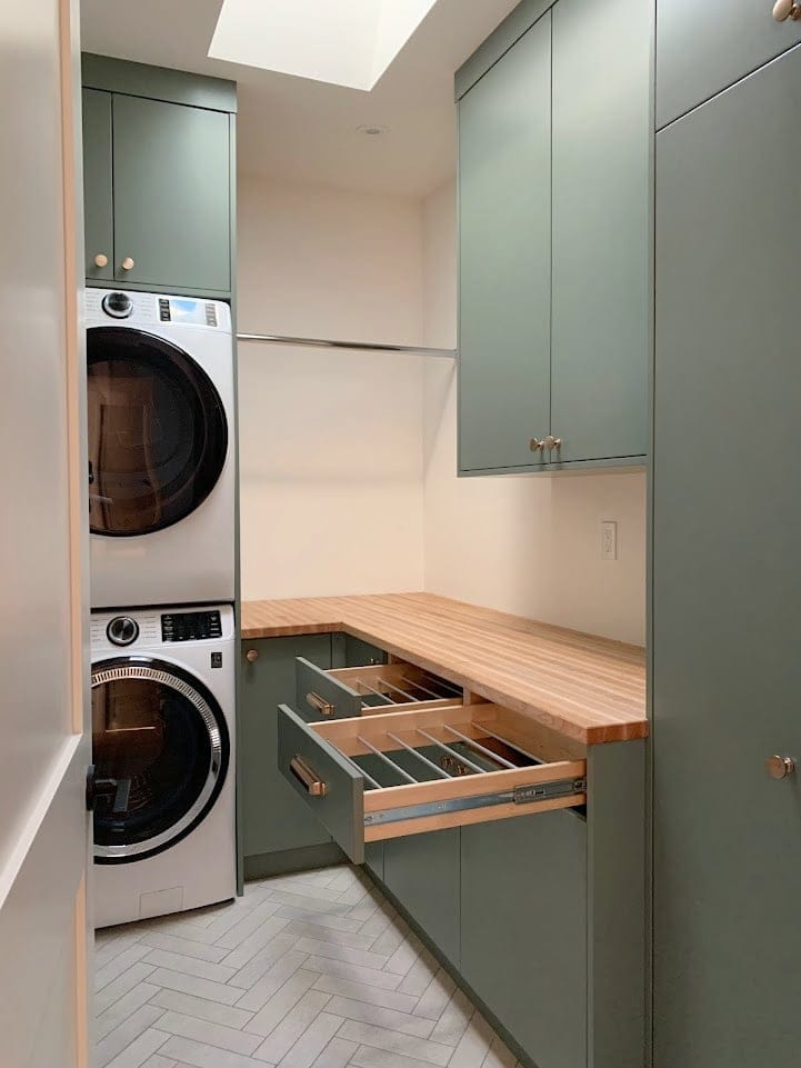Farrow and Ball Green Smoke green painted laundry room flat panel cabinets, butcher block countertops. Kylie M Interiors Edesign