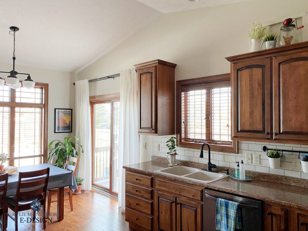 Kitchen with oak cabinets, dining room oak wood trim, Sherwin Williams White Duck, diy handpainted subway tile backsplash, granite look lamiante countertop, Kylie M Interiors Edesign