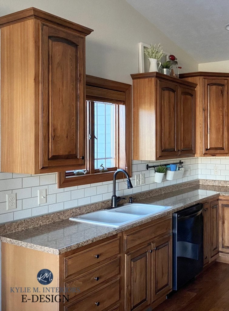 Oak wood cabinets, handpainted diy subway tile backsplash, budget-friendly udpateideas, laminate formica granite look countertop, wood trim. Kylie M Interiors Edesign