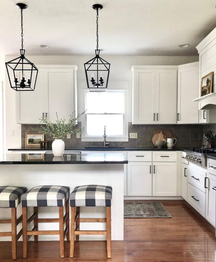 Painted white kitchen cabinets, black granite countertop, beige taupe backsplash tile, Sherwin Williams Alabaster cabinets, Kylie M and Jenna Christian