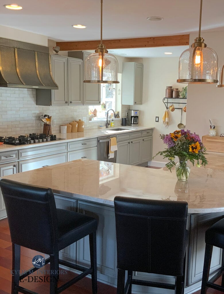 Sherwin Williams Felted Wool painted greige kitchen cabinets, Taj Mahal quartzite countertops, new light pendants, gold hardware, peninsula, Natural Linen Sherwin Williams paint on walls. Kylie M, online paint color expert, kitchen update
