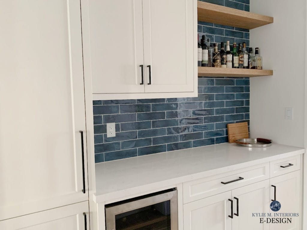 White Dove butlers pantry cabinets, Calacatta Botanica white quartz countertop, blue backsplash tile, wood floating shelves, black hardware. Kylie M Interiors Edesign