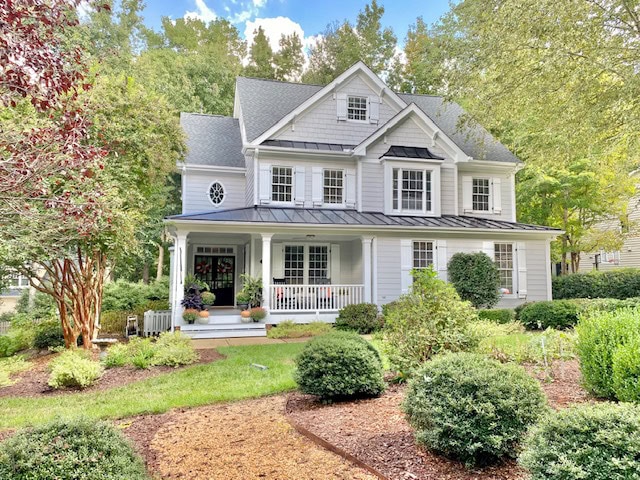 Exterior siding painted best gray paint colour, Sherwin Williams Knitting Needles, dark gray black roof, white porch. Kylie M Interiors