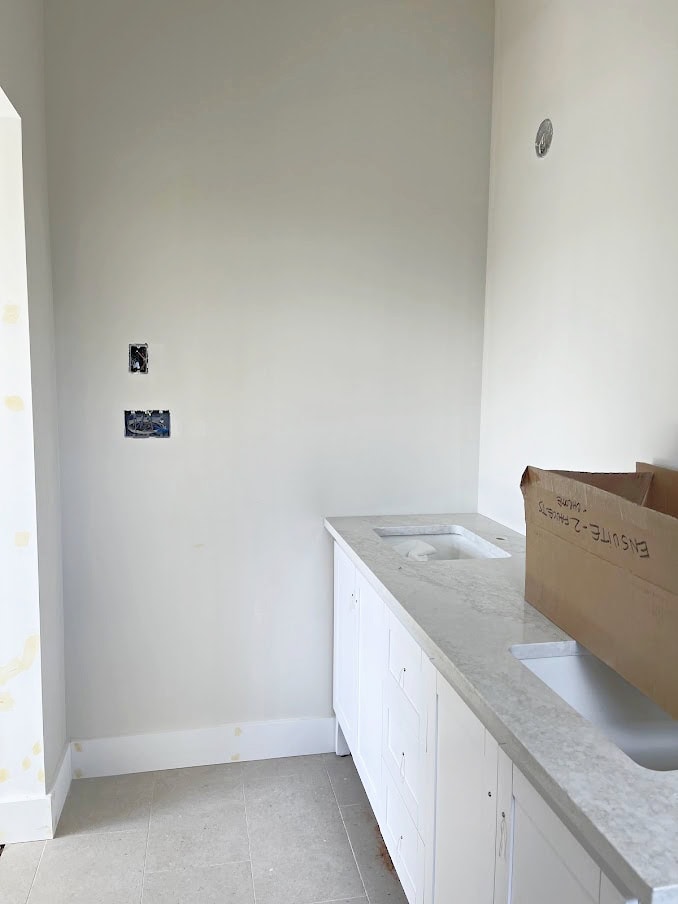 monterey omnia beige warm quartz countertop, Aesthetic White walls, beige tile floor.