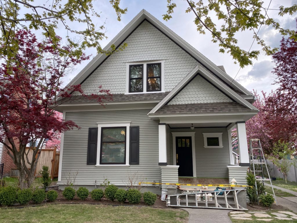 Aloof Gray and Rare Gray exterior with black shutters and white trim.