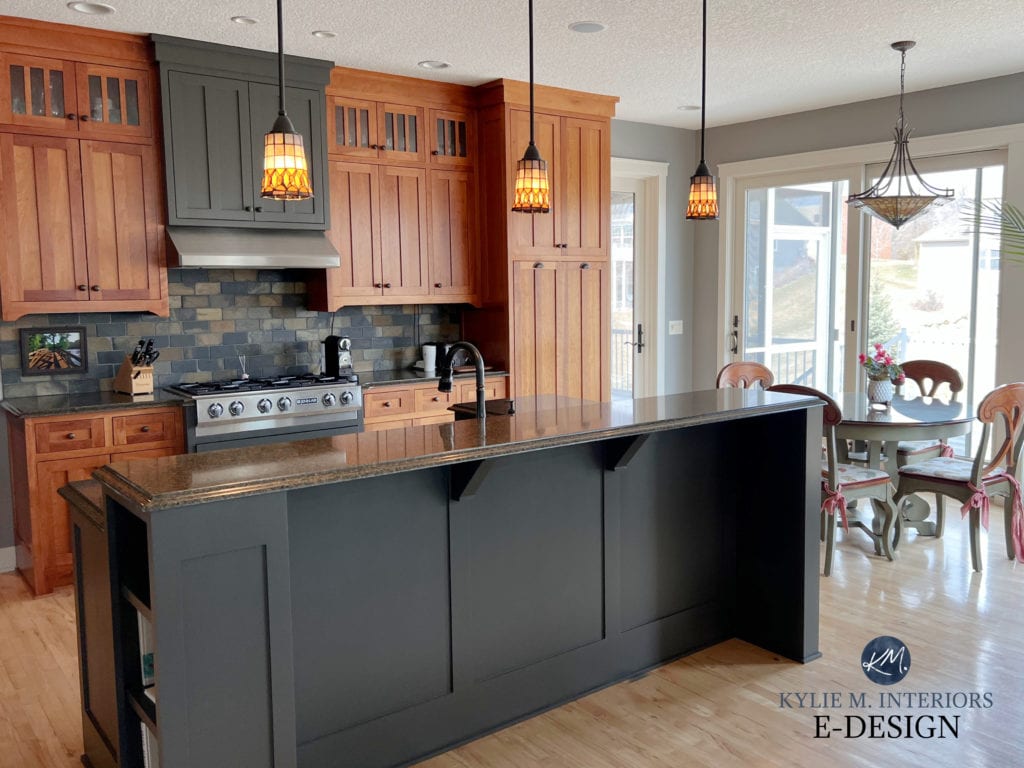 Benjamin Moore Graystone paint colour on walls, dark green undertone gray painted island with wood cabinets, slate tile backsplash, black countertop, light wood floor. Kylie M Edesign