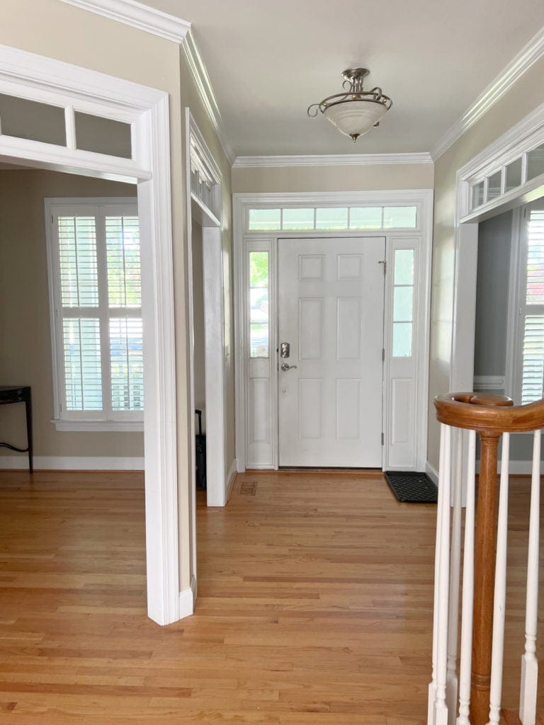 The best tan beige paint colour, Manchester Tan, yellow orange oak flooring, white trim.