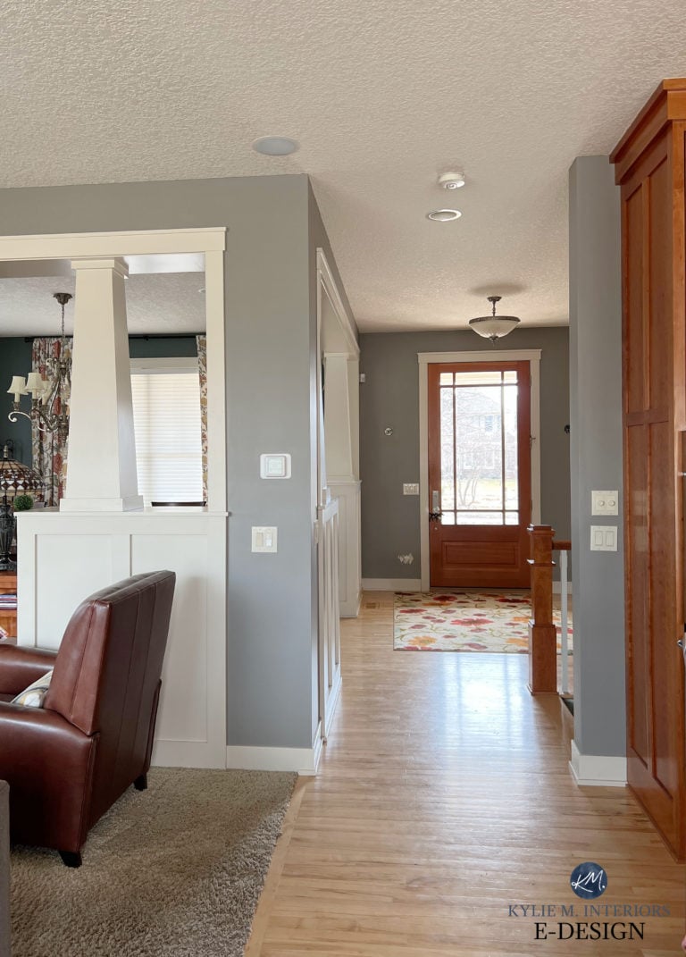 Cherry or fir front door with white trim, Benjamin Moore Graystone paint color on walls. Kylie M