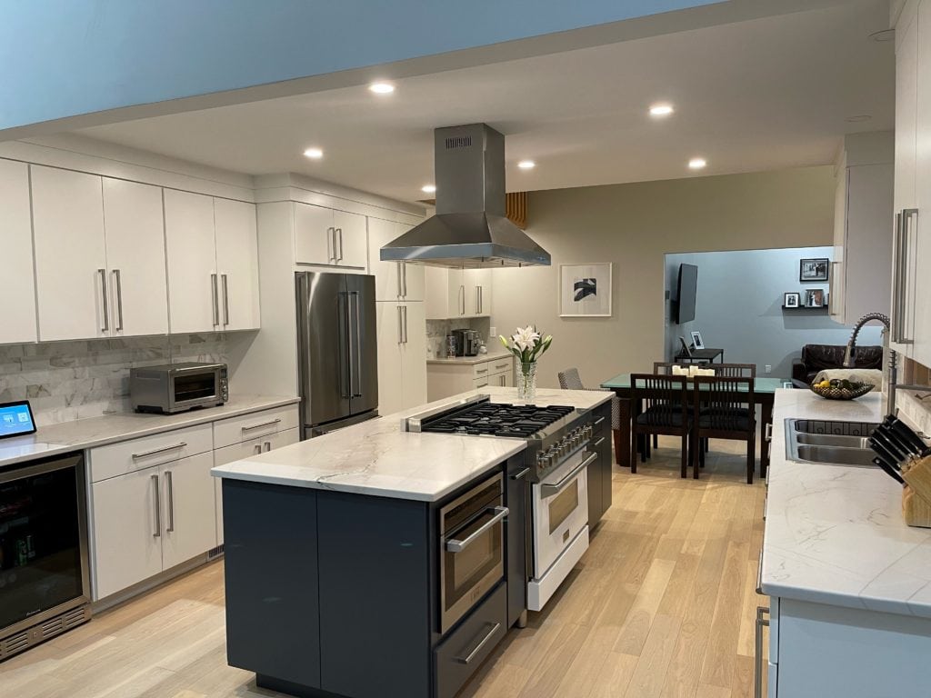 Kitchen remodel, flat panel cabinets Sherwin Williams Pure White, Big Chill gray on walls, white quartz countertop, Cyberspace painted island, white oak flooring