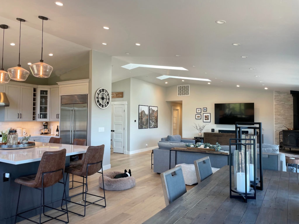 Open concept great room, kitchen, living room, Sherwin Williams Repose Gray on walls, light wood floor. Kylie M