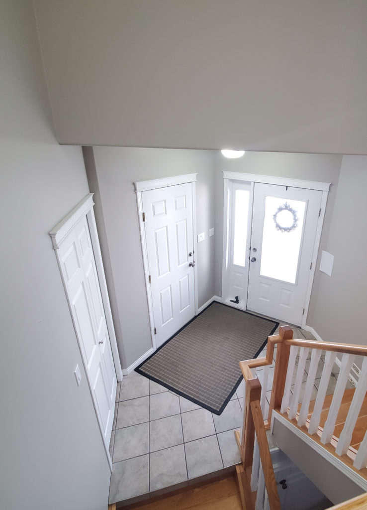 Sherwin Williams Anew Gray, foyer with warm gray taupe greige tile. White trim, best greige paint colour