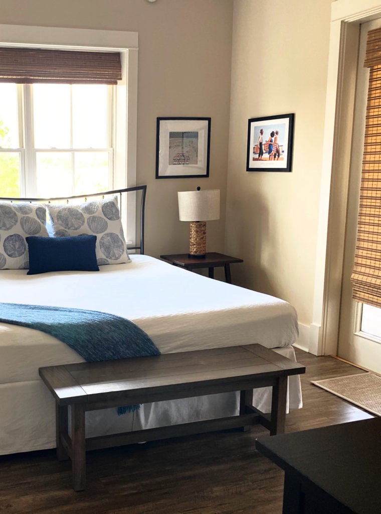 Sherwin Williams Softer Tan, popular warm beige paint colour with blue accents in bedroom.