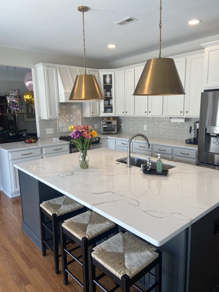 origami white cabinets, iron ore painted wood island. White quartz marble look countertop, kitchen cabinets painted