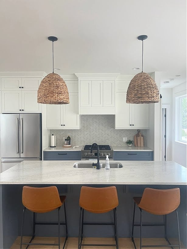 fulgor counter depth fridge and range, kitchen with white upper cabinets, blue island and lowers