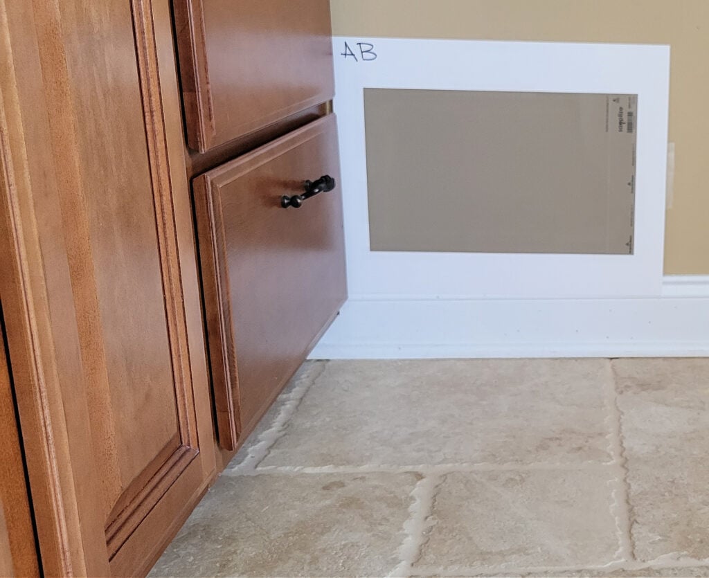 Benjamin Moore Alexandria Beige with travertine tile floor, wood cabinet in bathroom. Kylie M Edesign