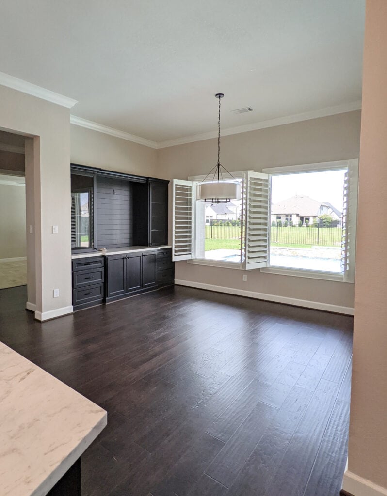 Dark wood flooring and built-in, Sherwin Williams Accessible Beige, Benjamin Moore White Dove trim, Kylie M paint color blogger
