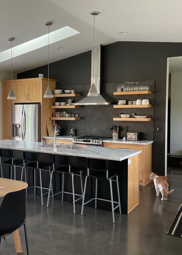 Iron Ore soft black feature accent wall in kitchen with formica marble look countertop, concrete floor. Budget friendly ideas to update, Kylie M