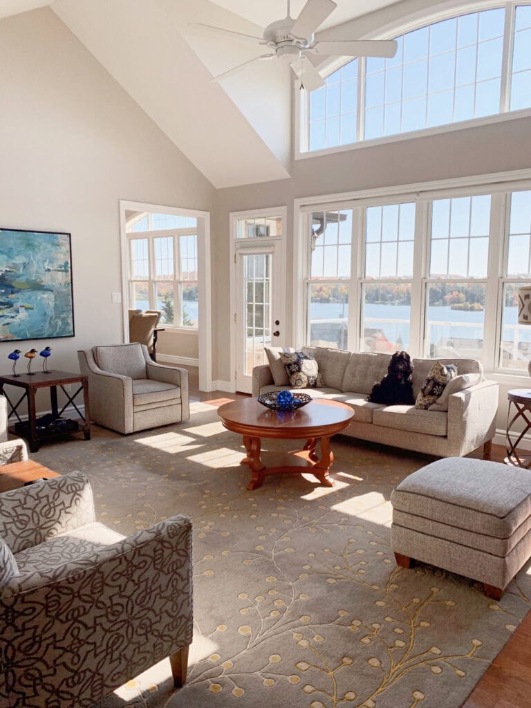 Sherwin Williams Agreeable Gray, best greige, vaulted ceiling, white trim, ocean or lake view, neutral furniture. Kylie M Edesign