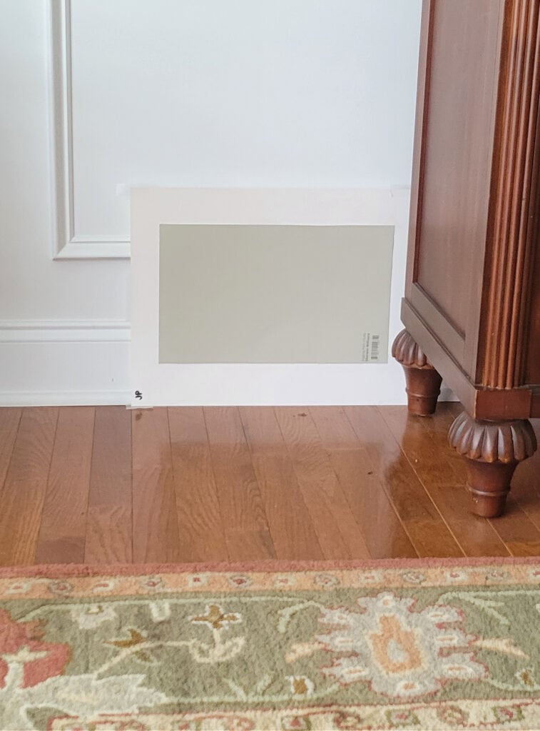Sherwin Williams Jogging Path with red oak flooring, cherry wood furniture, white wainscoting. Kylie m